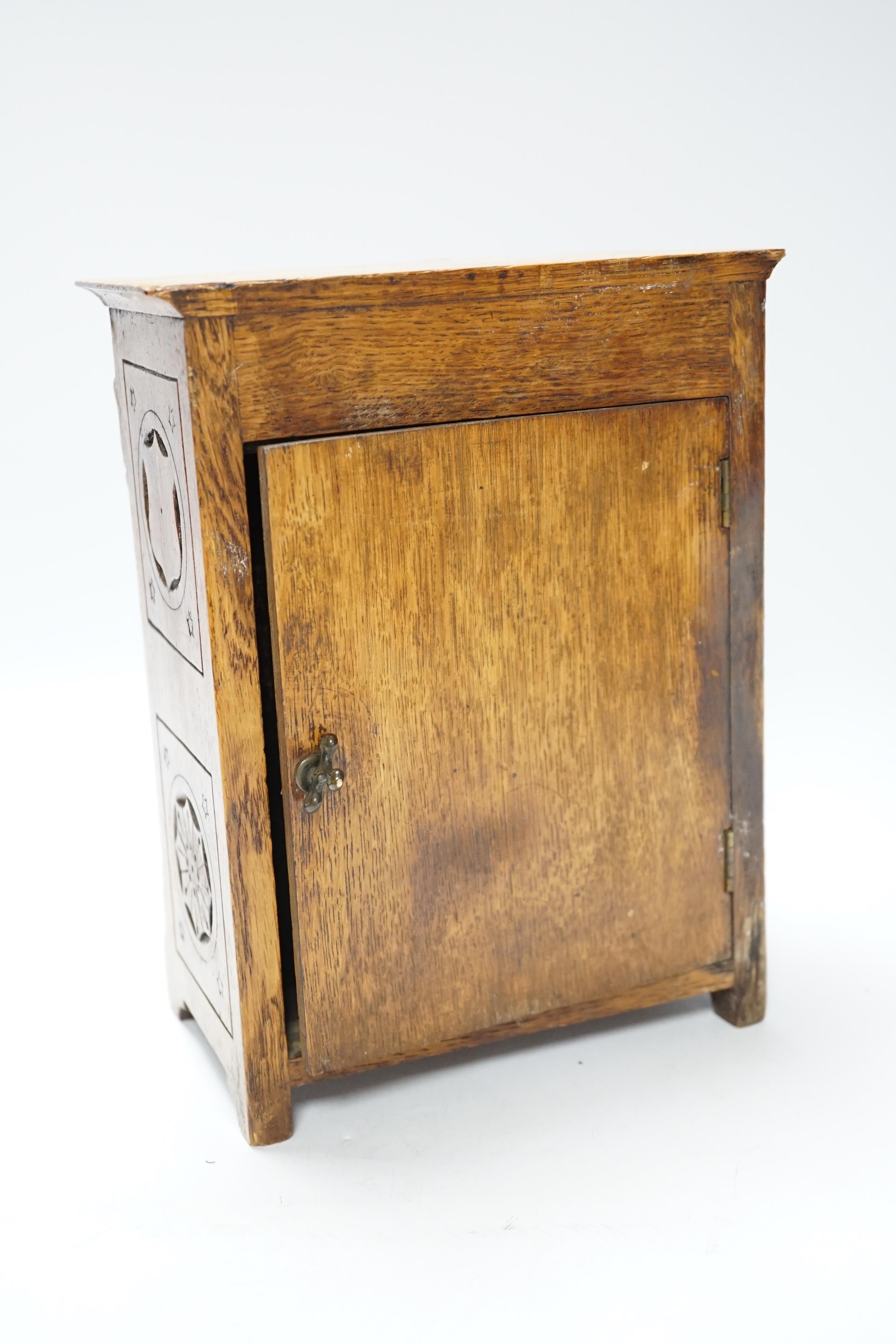 A Victorian carved oak aesthetic mantel clock, 24cm high